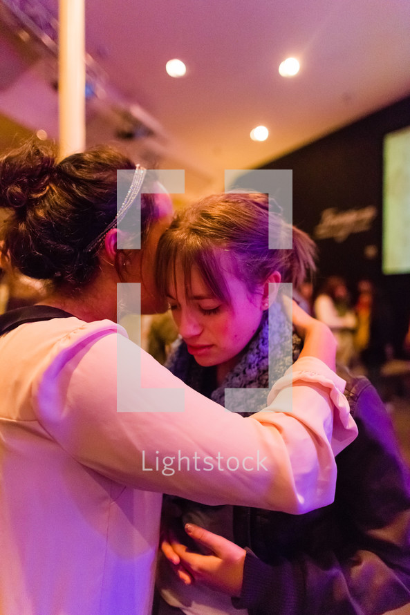 Woman praying for another woman, girl, laying of hands, prayer, faith