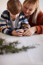 mother and son looking at a cellphone screen 