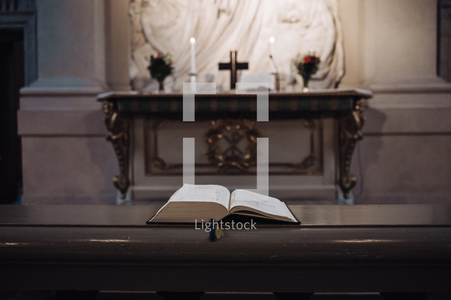 open Bible on a church railing at the altar 