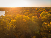 aerial view over lake and swamp in fall at sunset 