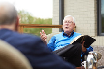 Man talking in older men's Bible study