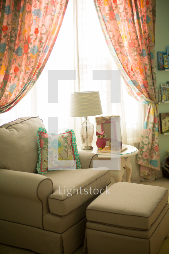 armchair and ottoman near a window 