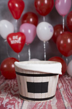 barrel and red balloons 