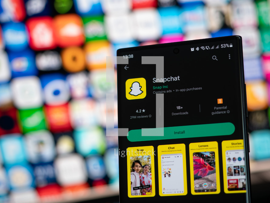 Snapchat app on phone with colorful grid of apps in background