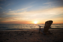 adirondack chair on a beach 