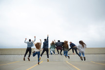 group of teens jumping in celebration 