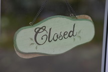Closed sign hanging on a door 