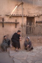 men talking in a village in biblical times 