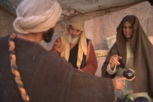 men and women talking in a tent in biblical times 