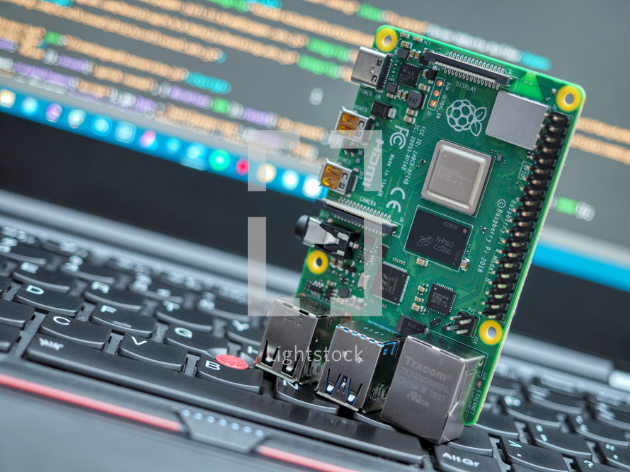 Close-up of a Raspberry Pi 4 Model-B on a laptop keyboard.