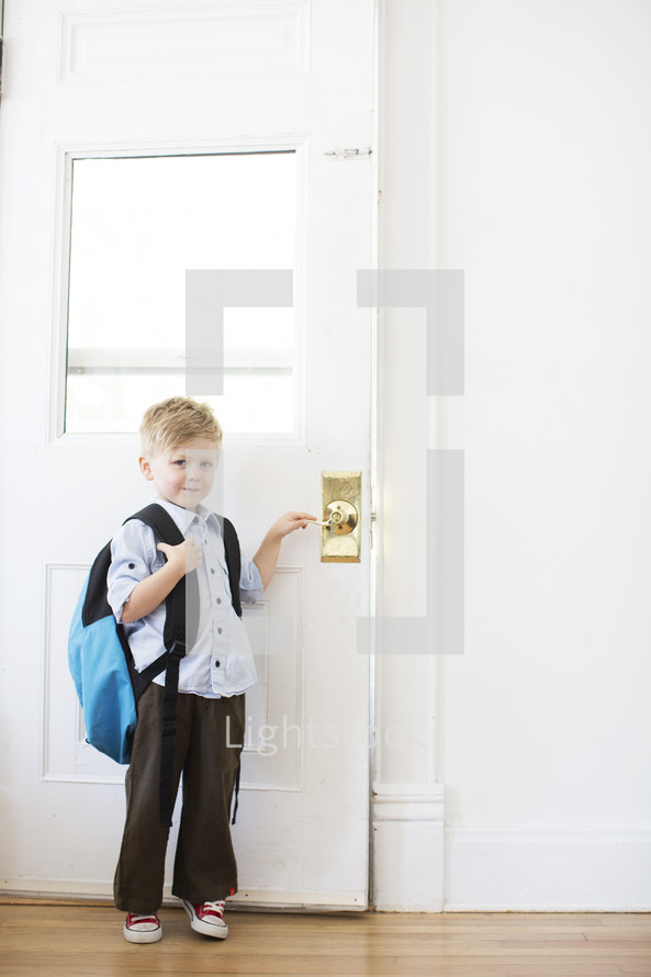 boy child standing at a door - first day of school 
