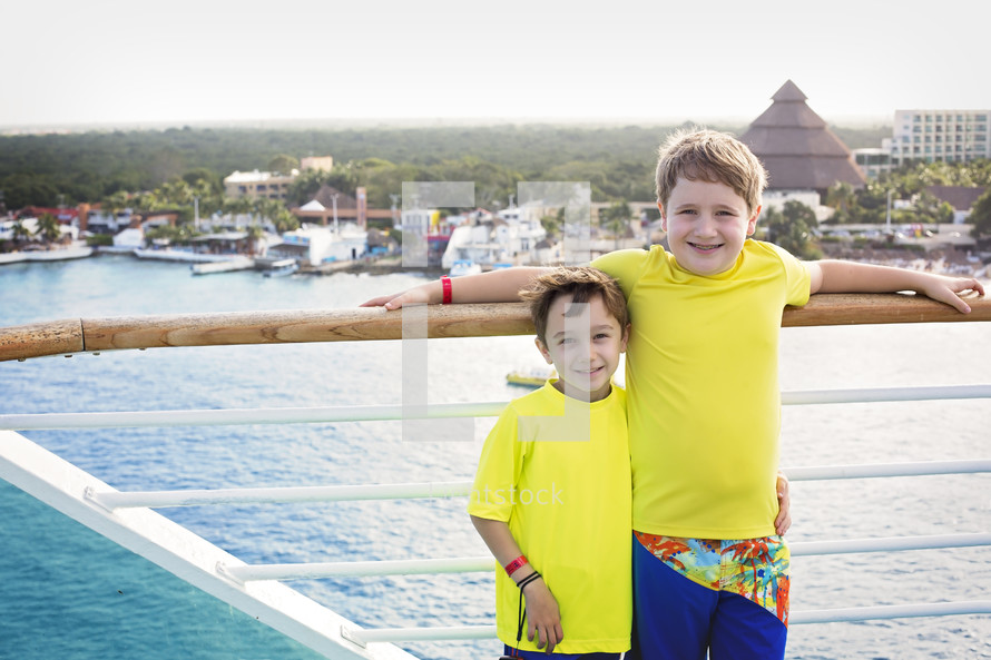 kids standing on a cruise ship deck 