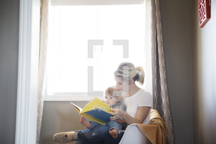 mother and son reading a book together 