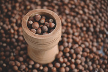 Hazelnuts in a wooden bowl on rustic background