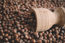 Hazelnuts in a wooden bowl on rustic background