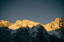 sunlight on snow capped mountains peaks 
