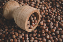 Hazelnuts in a wooden bowl on rustic background