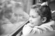 girl looking out a train window 