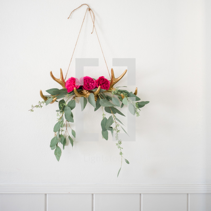 antlers holding flowers and eucalyptus