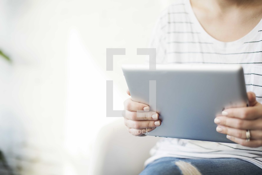 a woman holding a tablet 