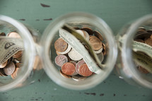 money divided in jars 