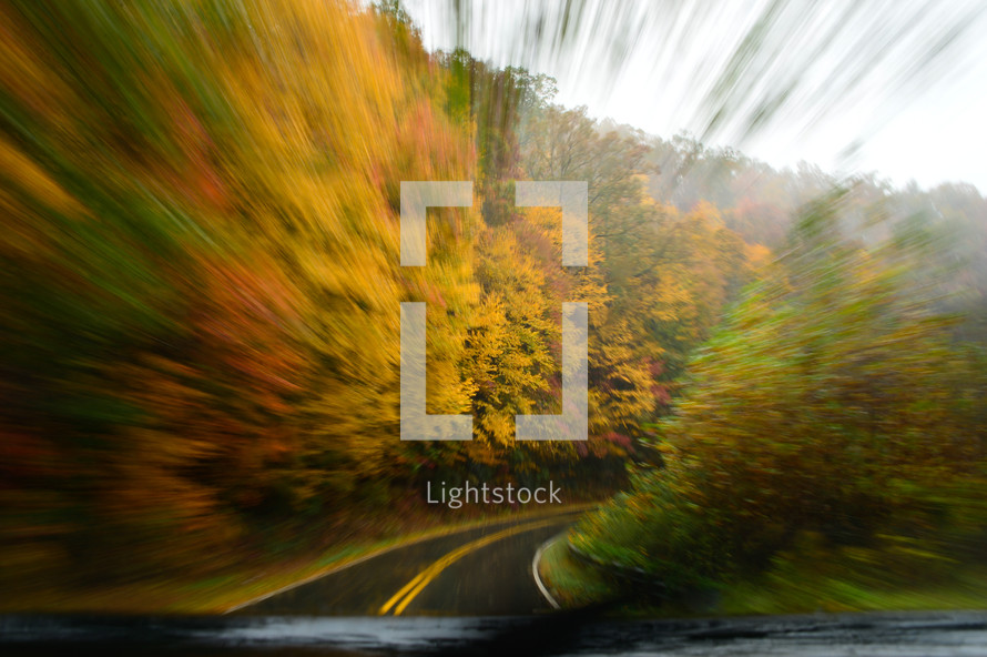 blurry drive through a mountain road in autumn 