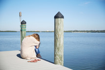 a woman crying on a pier 