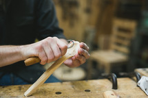 man carving wood 