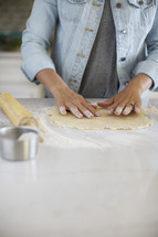 A woman making a pie crust.