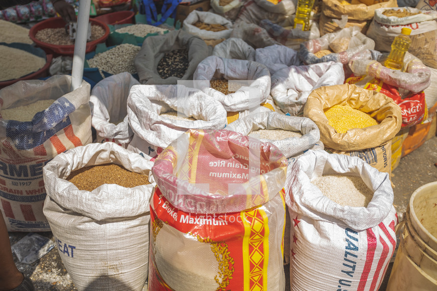 sacks of grains at an outdoor market 