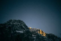 sunlight on a snow capped mountain peak 