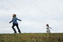 children running in grass outdoors 