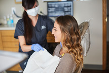 a dental hygienist with her patient 