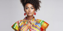 Vibrant portrait of a young woman with bold makeup and colorful striped attire.