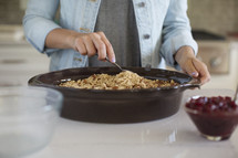 A person stirring ingredients together in a bowl.
