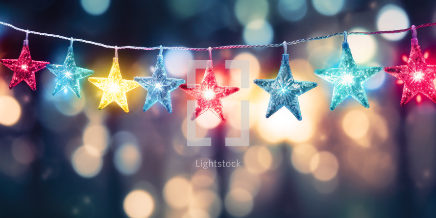 Christmas background with colorful star shape garland and glitter light bokeh.