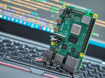 Close-up of a Raspberry Pi 4 Model-B on a laptop keyboard.