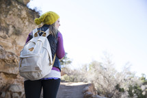 woman with a backpack on a trail 