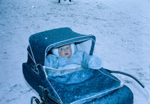 vintage image of a baby in a baby buggy 
