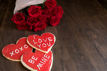 Valentine's cookies and bouquet of red roses 