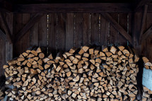 stacked firewood in a shed 