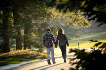 a couple walking holding hands outdoors