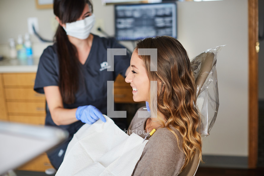 a dental hygienist with her patient 
