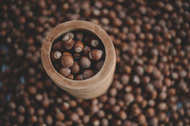 Hazelnuts in a wooden bowl on rustic background