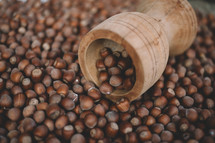 Hazelnuts in a wooden bowl on rustic background