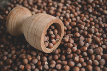 Hazelnuts in a wooden bowl on rustic background