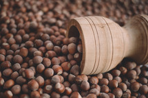 Hazelnuts in a wooden bowl on rustic background