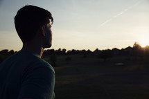 man standing outdoors at sunrise 