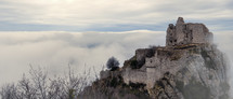 French winter landscapes. Stunning panoramic view of castle ruins Crussol. Foggy mountain landscape