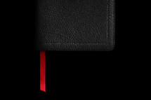 red ribbon bookmark in a Bible 